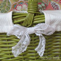 a wicker basket with white lace on it