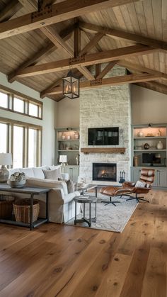 a living room filled with furniture and a fire place in the middle of an open floor plan