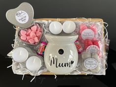 a basket filled with marshmallows, eggs and other candies in it