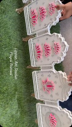 some pink and white decorative items in the grass