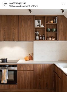 a kitchen with wooden cabinets and white counter tops