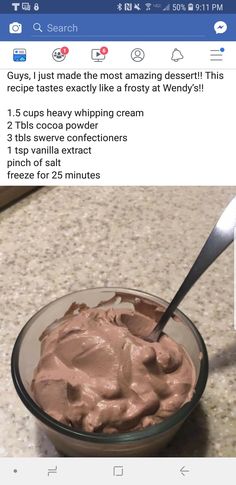 a bowl filled with chocolate frosting on top of a counter next to a spoon