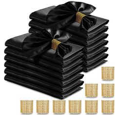 a stack of black napkins with gold bows