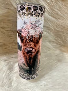 a travel mug with an image of a cow wearing a flower crown on it's head