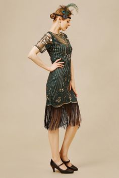 This fringed dress is classic vintage look for a modern woman. The eyecatching design features art deco print and unique vintage style which bring you back to the roaring twenties. Features: Paisley blossom pattern Sheer mesh sleeves design Irregular fringe hem Midi length dress 100% Polyester fabric Note: This dress comes with an unique size chart. Be sure to select your ideal fit from the chart before making your purchase. Cocktail Flapper Dress With Fringe, Vintage Beaded Fringe Flapper Dress, Vintage Knee-length Flapper Party Dress, Vintage Knee-length Flapper Dress For Party, Gatsby Style Beaded Fringe Cocktail Dress, Fitted Flapper Dress With Tassels For Cocktail, Summer Knee-length Gatsby Flapper Dress, Knee-length Vintage Flapper Party Dress, Flapper Fringe Cocktail Dresses