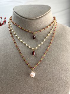 Buy individually or as a set & save!Choose from beautifully faceted Garnet rosary style chain, accented with lustrous Freshwater Pearls. Gorgeous classics with a bit of flair & color!Necklace: Rosary style faceted Garnets are accented with a lustrous 9 X 10mm Freshwater Pearl, which is hand wired to the center of the necklace. The Pearl pendant can be removed if you choose to wear them separately or the pendant on a different chain.Length: 16" with 2" extenderBracelet: Faceted Garnets are wire w Faceted Multi-strand Necklace As Gift, Faceted Multi-strand Necklace For Gift, Elegant Faceted Oval Bead Necklaces, Garnet Rosary, Station Bracelet, Pearl Drop Necklace, Color Necklace, Garnet Pendant, Drop Necklace