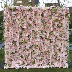 an artificial flower wall in the shape of a rectangle with pink and white flowers