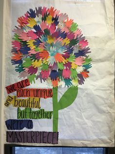 a bulletin board with colorful paper flowers on it