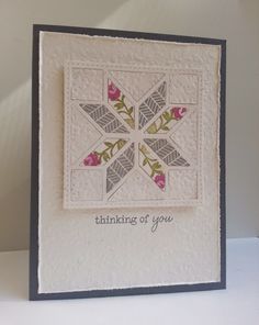 a card with an embroidered snowflake on the front and words thinking of you