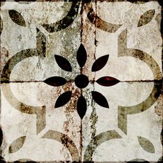 an artistic tile design with black and white designs on the floor, in shades of brown