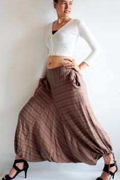 Beautiful double layer fabric made of cotton/linen blend.  High quality and stunning beauty. The fabric is unbleached and undyed, you can see the bark fibres in it! Subtle stripe patternDrop-crotch style pants, baggy pants, tribal pants with a twist.3 ways to wear. with drawstring on the hem. You can wear it with drawstring loose. Like a wide leg pants. Even look like A shape sweet skirt.You can also draw the string and get a balloon shape pants.Or...you can put the hem above your knee and get a Bohemian Harem Bottoms With Relaxed Fit, Hippie Style Cotton Pants For Fall, Brown Relaxed Fit Harem Pants For Spring, Non-stretch Cotton Harem Pants For Loungewear, Bohemian Harem Trousers For Fall, Fall Bohemian Harem Pants, Brown Cotton Harem Pants For Fall, Bohemian Cotton Wide Leg Ankle-length Pants, Bohemian Harem Pants Ankle-length For Fall