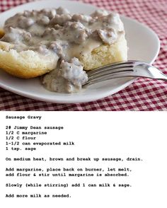 a white plate topped with biscuits covered in gravy