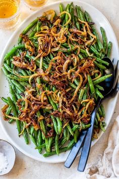 a white plate topped with green beans and onions