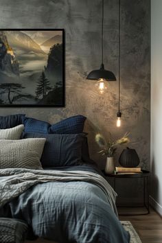 a bed with blue and grey pillows in a bedroom next to a painting on the wall