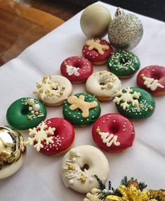 there are many decorated doughnuts on the table