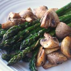 asparagus and mushrooms on a white plate