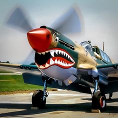 an airplane with a shark's mouth painted on it