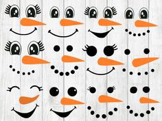 the snowman faces are drawn on wood planks with black dots and orange noses