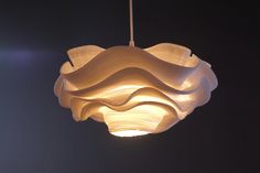 a large white light hanging from a ceiling