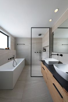 a bathroom with two sinks and a bathtub