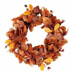 a wreath made out of dried leaves and acorns is shown on a white background