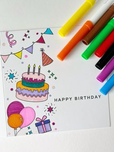 a birthday card with markers and crayons next to it