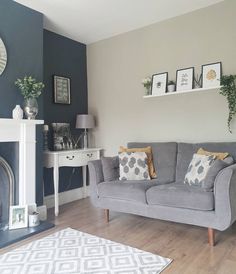 a living room filled with furniture and a fire place in front of a wall mounted clock