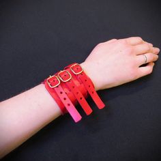 Add a touch of edgy style to your look with this handmade leather bracelet! Made from genuine leather, this bracelet features three straps with buckles for an adjustable and comfortable fit. Choose from bold red, classic black, or mix and match both colors for a unique look. The cuff is 6 cm (2.3 inches) wide and adjustable to fit wrist sizes ranging from 16 cm (6.3 inches) to 21 cm (8.3 inches). This statement piece is ideal for those with gothic or punk style sensibilities, adding an extra lay Red Adjustable Leather Bracelet, Adjustable Red Leather Bracelet, Adjustable Red Bracelet With Leather Strap, Adjustable Red Leather Strap Bracelet, Handmade Leather Bracelets, Black Leather Bracelet, Alternative Style, Gothic Style, Edgy Look