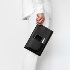 a person in white pants holding a black bag