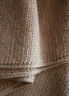 two brown knitted blankets sitting next to each other