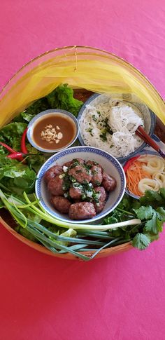 a bowl filled with lots of food on top of a pink tablecloth covered floor