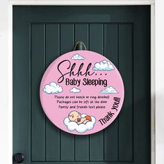 a pink sign that says she's baby sleeping on top of a black door