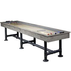 a long table that is made out of wood and metal pipes with an air hockey board on top