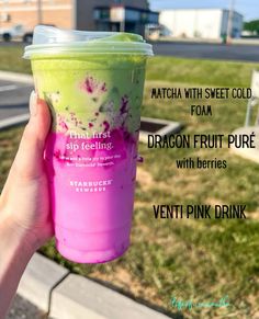 a hand holding up a pink and green drink in front of a parking lot with the words matcha with sweet cold form from dragon fruit pure with berries