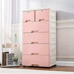 a white and pink dresser next to a window