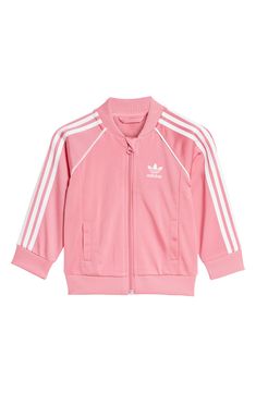 Start your little one off right in this sporty and sustainable track suit cut from recycled-polyester tricot and marked with all the classic adidas details. Jacket has front zip closure; welt pockets Bottoms have elastic waist 100% recycled polyester Machine wash, tumble dry Imported Pink Athleisure Activewear With Ribbed Cuffs, Pink Long Sleeve Tracksuit For Jogging, Adidas Spring Activewear With Three Stripes, Adidas Activewear With Three Stripes For Spring, Pink Stretch Track Jacket For Sports, Pink Athleisure Tracksuit For Jogging, Pink Adidas Moisture-wicking Activewear, Adidas Pink Moisture-wicking Activewear, Pink Moisture-wicking Adidas Activewear