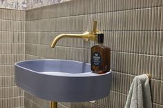 a bathroom sink with a soap dispenser next to it