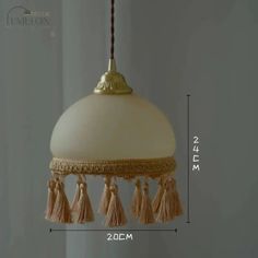 an image of a light fixture with tassels on the side and measurements for it