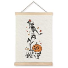 a skeleton hanging on a wall with the words it's the most wonderful time of the year