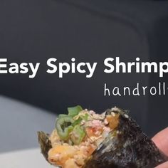 a hand holding up a piece of food with the words easy spicy shrimp on it