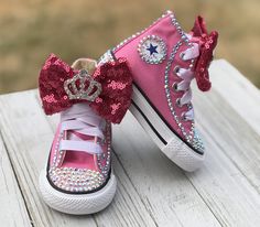 Princess Bling Converse Touch of Bling Sneakers These authentic Pink Converse have a touch of bling on the toe, Converse emblem and back of the shoe. They are accessorized with a sequin bow and rhinestone crown. This listing is for little kid size 10-2. Information about the shoes All sneakers are Converse brand and have hand applied high quality glass crystals. Converse sizing is unique and sneaker specific. Converse Kids Chuck Taylor All Star Sneakers are expected to run a half-size large. Cus Bling Converse Shoes, Bedazzled Converse, Ladybug Tutu, Bling Sneakers, Dresses Halloween, Bling Converse, 1st Birthday Tutu, Handmade Tutu, Baby Bling