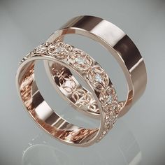 two gold wedding bands with diamonds on each one and the other in rose gold, set against a gray background