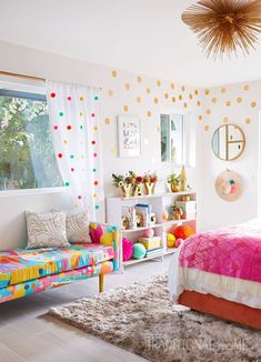 a brightly colored bedroom with polka dots on the walls