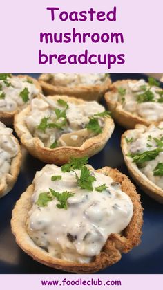 there is a blue plate topped with mini mushroom bread cups