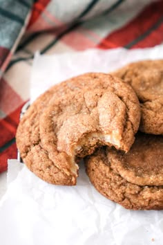 three cookies are stacked on top of each other with one bite missing from the cookie