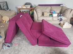 a living room filled with furniture and lots of clutter on the floor next to couches