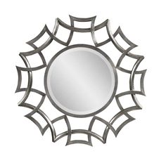 a mirror that is sitting on top of a white wall with an intricate design around it