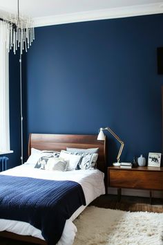 a bedroom with blue walls and white carpet