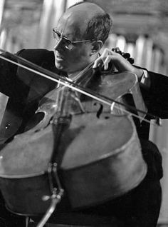 a man is playing the cello in black and white