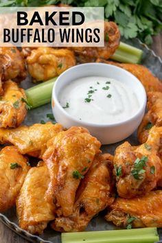 baked buffalo wings with ranch dip and celery sticks on a platter for dipping